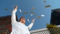 CLOSE UP: Smiling man celebrating winning the lottery by tossing money in air Royalty Free Stock Photo