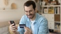 Close up smiling man wearing glasses making secure internet payment Royalty Free Stock Photo