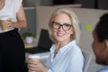 Close up smiling mature businesswoman listening to colleague Royalty Free Stock Photo