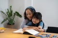 Close up smiling mature grandmother reading book to little granddaughter, telling interesting fairytale story, loving Royalty Free Stock Photo