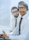 Close up.smiling operator, sitting at his Desk Royalty Free Stock Photo