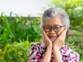 Close-up of smiling senior woman and hands touching on her face Royalty Free Stock Photo