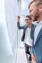 Close up. smiling staff looking at the Bulletin Board. Royalty Free Stock Photo