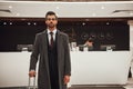 Close-up of a smiling successful businessman pulling suitcase Royalty Free Stock Photo