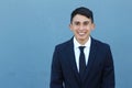 Close-up of smiling very young male on blue background with copy space