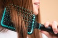 Close Up Smiling Woman Brushing Hair With Comb. Beautiful Girl With Long Hair Hairbrush.
