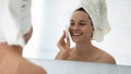 Close up smiling woman cleaning skin with facial cleansing sponge Royalty Free Stock Photo