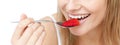 Close-up of a smiling woman eating a strawberry Royalty Free Stock Photo