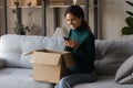 Close up smiling woman using smartphone, unpacking online order Royalty Free Stock Photo