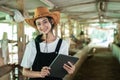 close up of a smiling woman wearing a cowboy hat carrying a digital tablet Royalty Free Stock Photo