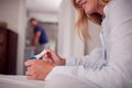 Close Up Of Smiling Woman Wearing Pyjamas In Bedroom Holding Positive Pregnancy Test Royalty Free Stock Photo