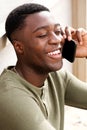 Close up of smiling young african american man talking on phone outdoors Royalty Free Stock Photo