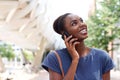 Close up smiling young african american woman talking on cellphone in the city Royalty Free Stock Photo