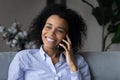 Smiling African American woman talk on smartphone call Royalty Free Stock Photo