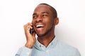 Close up smiling young black man talking with cellphone against isolated white background Royalty Free Stock Photo