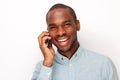 Close up smiling young black man talking with mobile phone against isolated white background Royalty Free Stock Photo