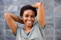 Close up smiling young black woman with hands behind head Royalty Free Stock Photo