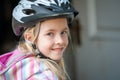 Close up of a smiling young blonde girl in a cycle helmet Royalty Free Stock Photo