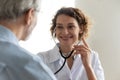 Smiling female nurse examine mature male patient Royalty Free Stock Photo