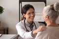 Smiling doctor support old lady patient in clinic