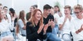 Close up. smiling young woman applauding sitting in conference room Royalty Free Stock Photo