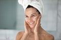 Close up smiling young woman applying face cream Royalty Free Stock Photo
