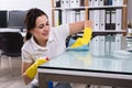 Woman Cleaning The Glass Office Desk With Rag Royalty Free Stock Photo