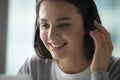 Close up smiling young woman employee wearing headset speaking Royalty Free Stock Photo