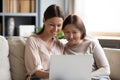 Close up smiling young woman with mature mother using laptop Royalty Free Stock Photo