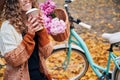 Smiling woman holding cup coffee or tea in park. Royalty Free Stock Photo