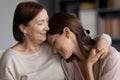 Close up smiling young woman and mature mother hugging Royalty Free Stock Photo