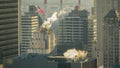 CLOSE UP: Smoke is emitted into air from industrial chimneys and skyscrapers. Royalty Free Stock Photo