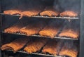 Smoke rising around a slow cooked beef brisket on a smoker barbecue grilling concept Royalty Free Stock Photo