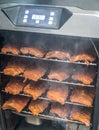 Smoke rising around a slow cooked beef brisket on a smoker barbecue grilling concept Royalty Free Stock Photo