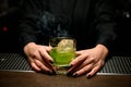 Close-up of smoking cocktail in bartender`s hands