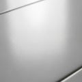 Close-up of a smooth, light gray or white surface with a slightly reflective finish. The Royalty Free Stock Photo