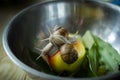 Close up snails Helix pomatia on an apple in a bowl in an apartment on a wooden table. The concept of growing and breeding Royalty Free Stock Photo