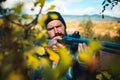 Close up snipers carbine at the outdoor hunting. Man holding shotgun. Hunter with shotgun gun on hunt. Deer hunt.