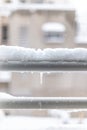 Close-up of snow accumulation on the window sill and an icicle.