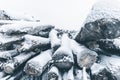 Close-up of snow covered logs in a pile. Horizontal layout Royalty Free Stock Photo