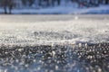 Close-up of snow flakes on the clear first ice on the river Royalty Free Stock Photo