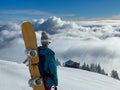 CLOSE UP: Snowboarder observes the mountain landscape before shredding slopes.