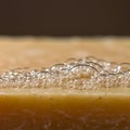 A close-up of a soap bar with a cluster of translucent, shimmering bubbles on its Royalty Free Stock Photo
