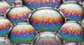Close-up of soap bubbles displaying iridescent patterns. The bubbles form a hexagonal structure Royalty Free Stock Photo