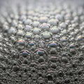 Close-up of Soap Bubbles on Surface with Iridescent Colors in Bright Lighting Royalty Free Stock Photo