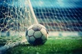 Close-up of a soccer ball (football) going into the back of the net with stadium background, generative AI Royalty Free Stock Photo