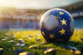 A close-up of a soccer ball with a unique star pattern resting on a grass field at sunset, symbolizing competition and sport Royalty Free Stock Photo