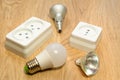 Close - up of sockets and white light bulbs on a light, wooden table. Royalty Free Stock Photo