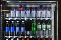 Close up of soda vending machine with rows of small water and lemonade plastic bottles