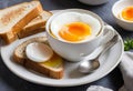 A close-up of a soft boiled egg in a cup with a slice of toast on the side Royalty Free Stock Photo